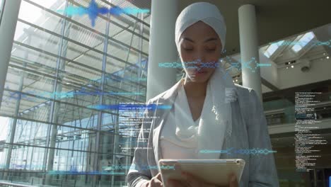 Animation-of-computer-language-and-soundwaves,-low-angle-view-of-biracial-woman-using-digital-tablet