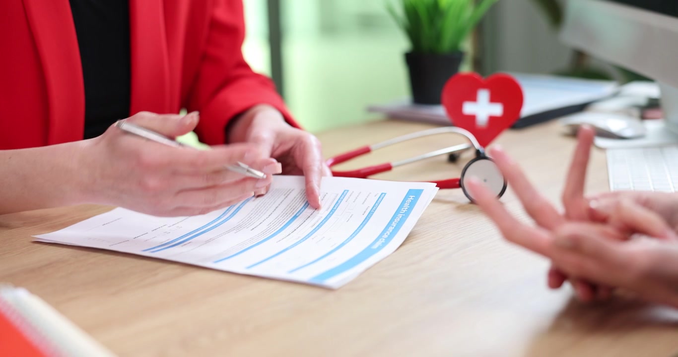 Woman doctor reviews patient form during clinic appointment