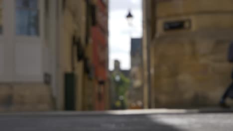 defocused shot of pedestrians and traffic on high street in oxford england 01