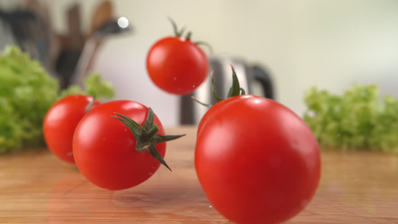 Cherry Tomatoes Falling Onto The Wet Wooden Cutting Board, Bouncing And Splashing Water Droplets in Macro and Slow Motion