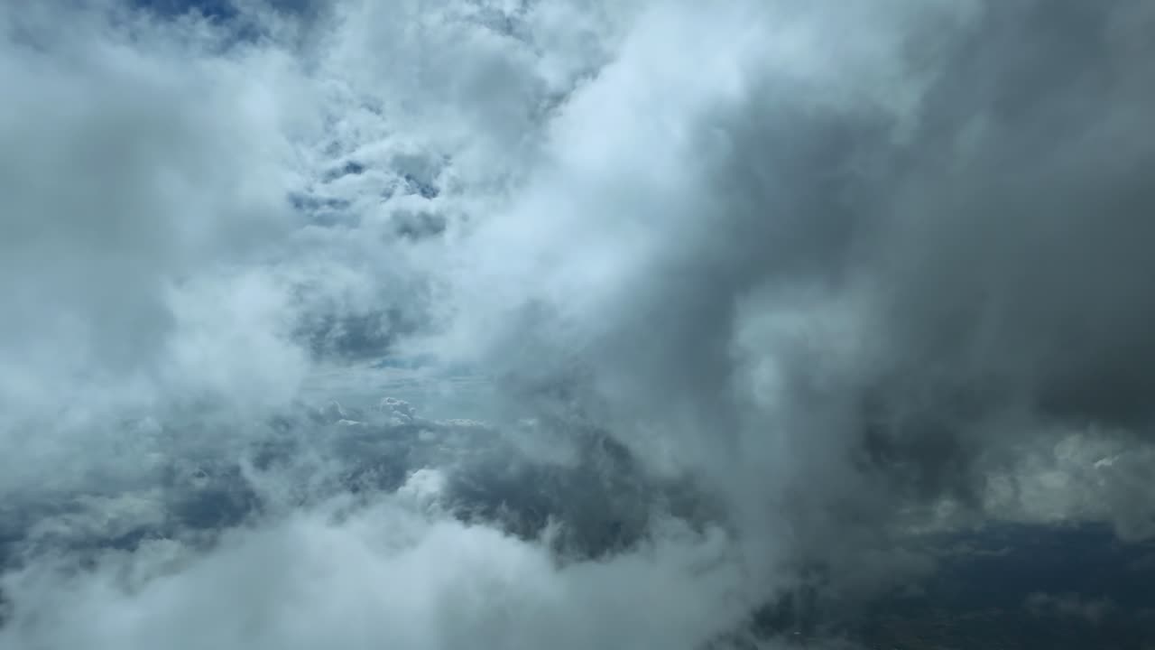 An immersive cockpit view while flying peacefully through ethereal layers of wispy clouds under a deep blue sky. ultra-realistic 4K shot