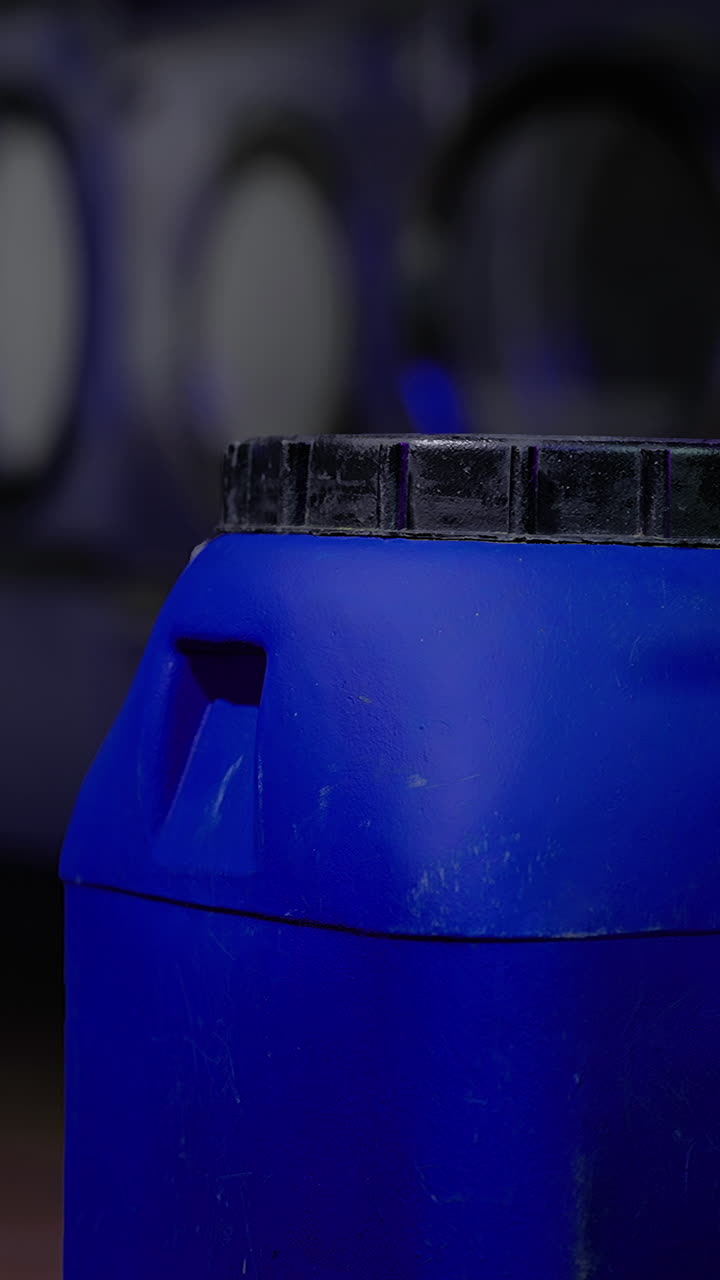 Blue container in a laundromat with washing machines in the background