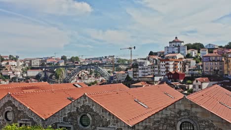 red-tiled rooftops and urban skyline of porto on a sunny day, captured from an elevated view