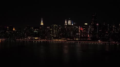 new york city skyline at night across the water