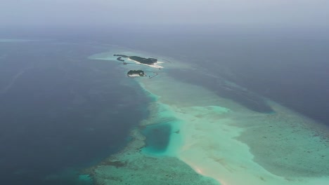 aerial view of isolated island of maldives , indian ocean, exotic tropical destination, drone shot