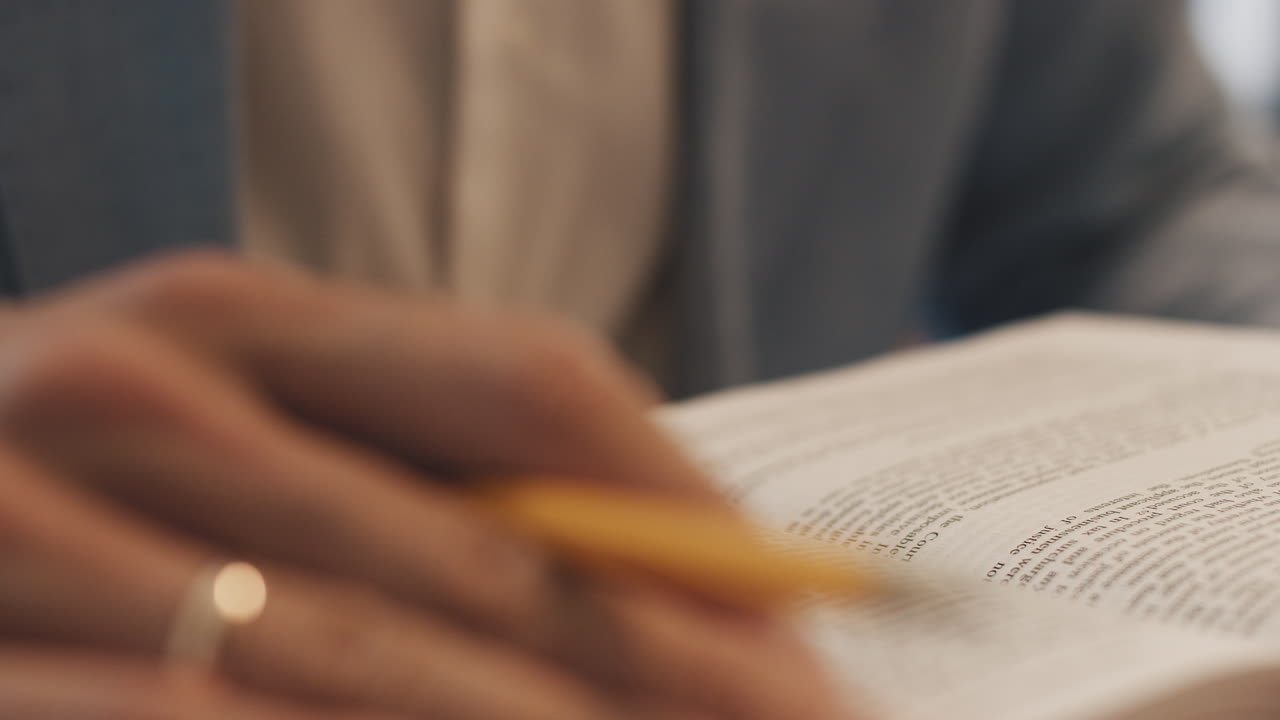 Unrecognizable lawyers hand works with papers and law books in courtroom or office concept of