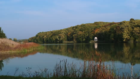 autumn park with lake and gazebo