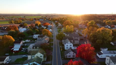 rising aerial reveals lancaster county pennsylvania farmland and small village in autumn