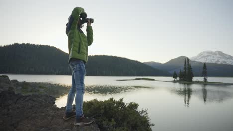 photographer takes photos of a beautiful mountain lake