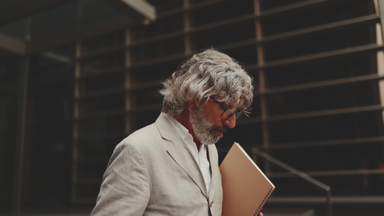 Mature Businessman Walking Outside Office Building