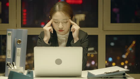 tired female office worker portrait of a young woman suffering from headache and discomfort while working overtime late at night low energy late time need sleep deadline computer yawn health insomnia