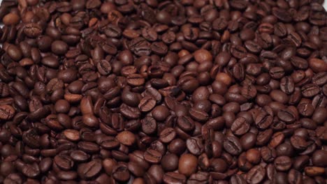 Tilt-Down,-Pile-of-Coffee-Beans-Isolated-on-White-Background,-Closeup