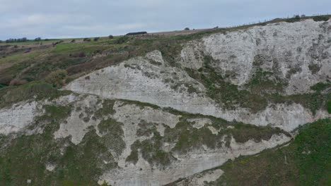 descending drone shot of zig zag pathway on the side of white cliffs of dover