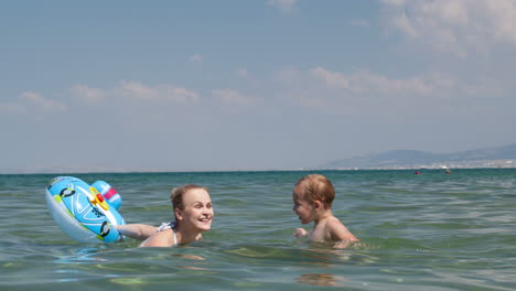 little boy swimming with his mother