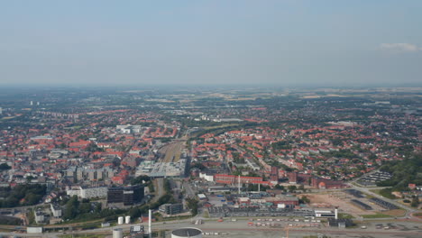 Aerial-view-flight-over-the-chimney-of-the-Esbjerg-Power-Station-In-Esbjerg.-Drone-view-mowing-toward-revealing-the-stunning-skyline-of-one-of-the-most-important-seaport-in-Scandinavia