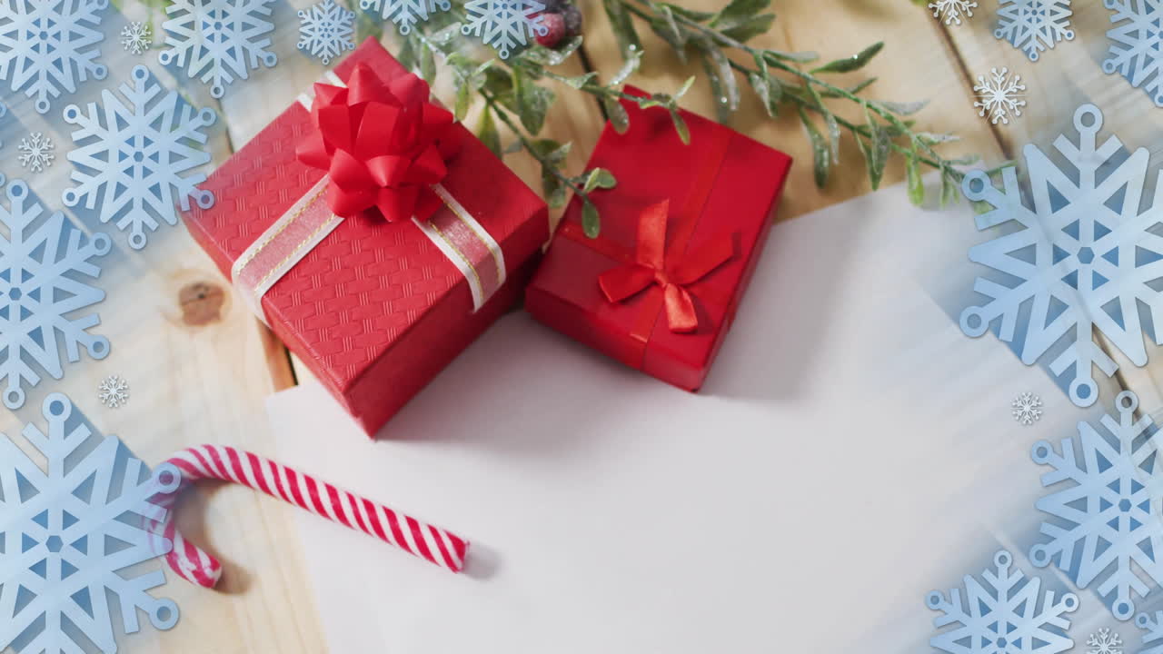 Animation of christmas gifts and decorations over snowflakes background