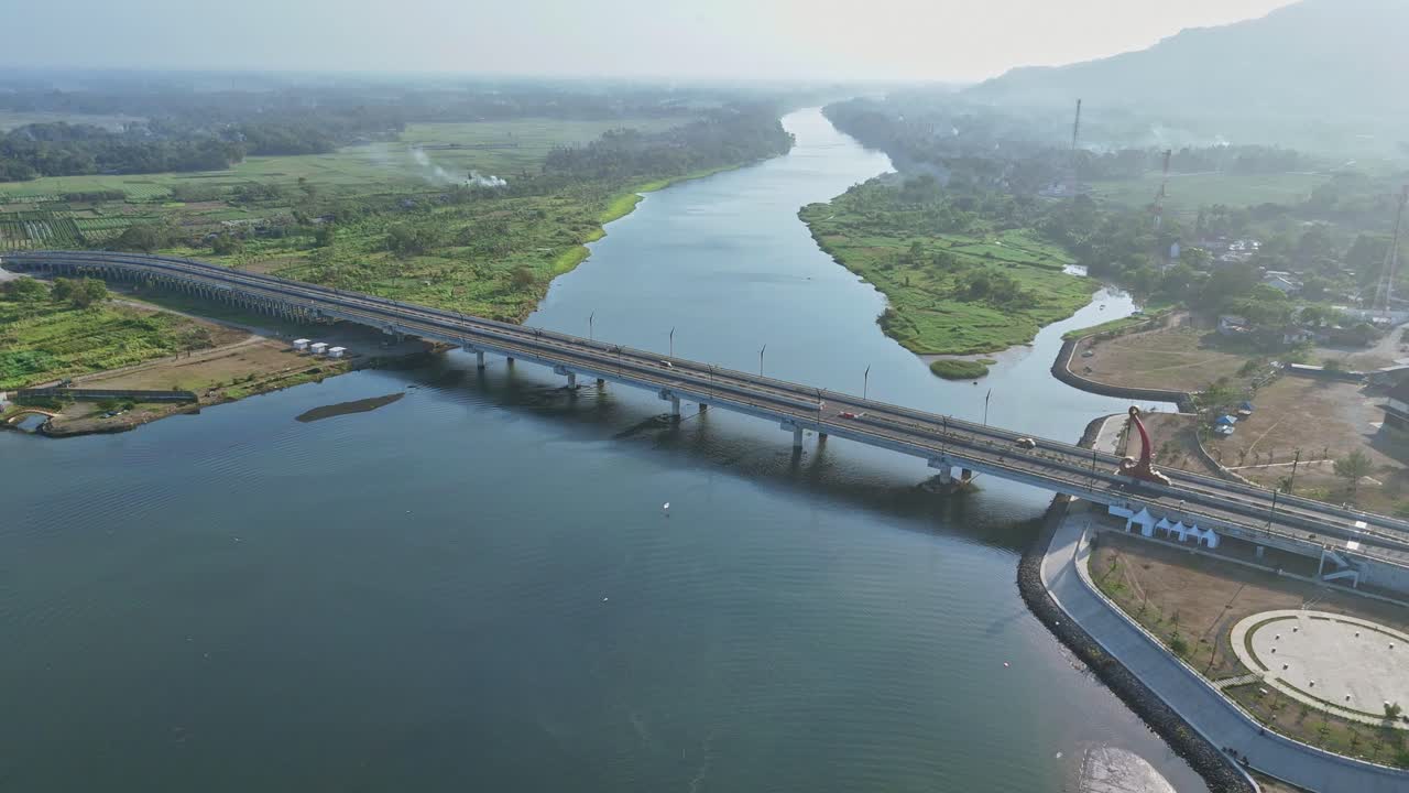 Aerial view of bridge on the big river. Indonesia. 4K drone shot.