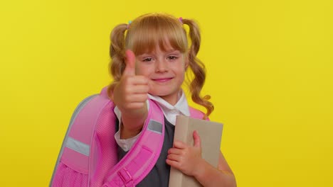 school girl kid looking approvingly at camera showing thumbs up, like sign positive something good