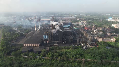 aerial view of a large industrial factory with smoke pollution
