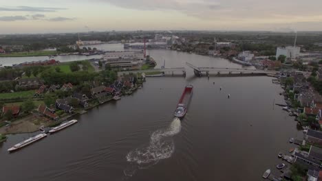 Ship-sailing-through-drawbridge-aerial-view