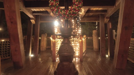 furnace in cabin decorated with warm christmas lights