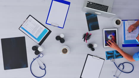 Top-view-of-doctor-researching-about-virus-using-tablet