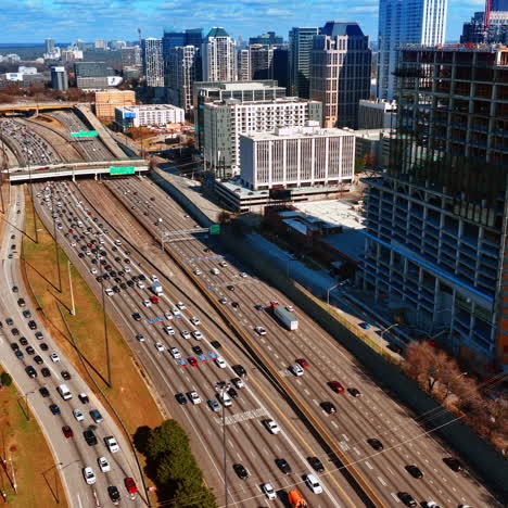 three wide-lane highways with lots of cars going by. panorama of atlanta, georgia, usa from top on sunny autumn day.