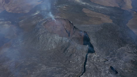 Fagradalsfjall-cone-volcanic-fissure-eruption,-fumes-gases-release.-Striking-aerial-drone-view-flying-backwards-and-forwards-volcano,-Iceland,-day