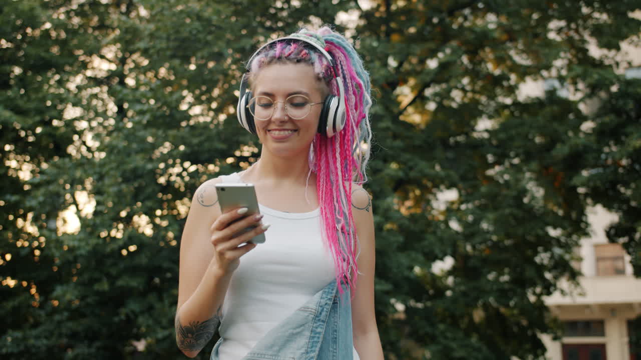 Young Woman Outdoors Using Smartphone with Headphones