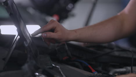 chip tuning machine master checker with computer under hood conducts chip tuning and flashing machine