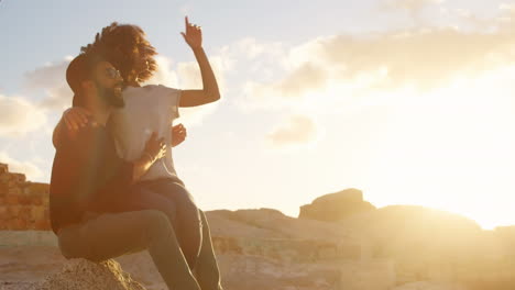 animation of red shapes over african american couple at beach