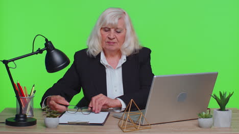 happy senior business woman dancing victory dance celebrating weekend holiday success win in office