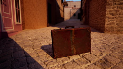 vintage suitcase on a cobblestone street in an old town