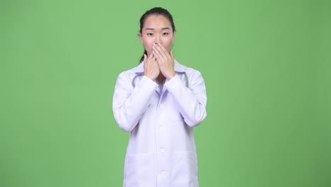 young beautiful asian woman doctor showing three wise monkeys concept
