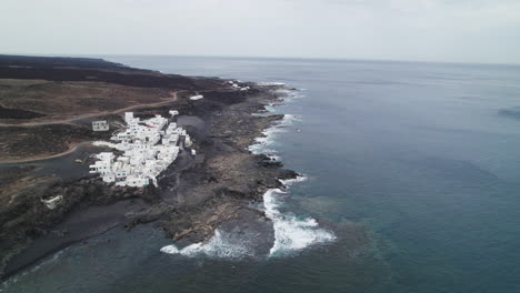 view of the tenesar village in lanzarote, canary islands, big waves crashing