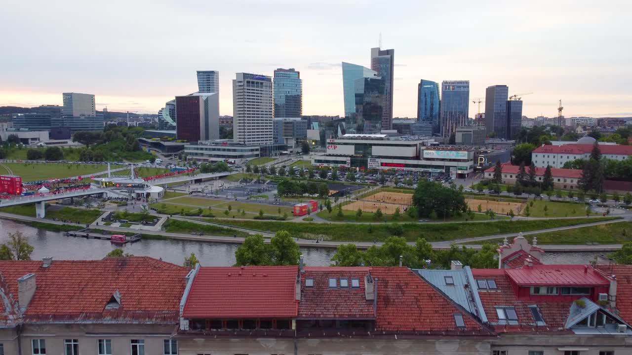 Aerial view of Vilnius city with historic buildings, modern skyscrapers, and green parks