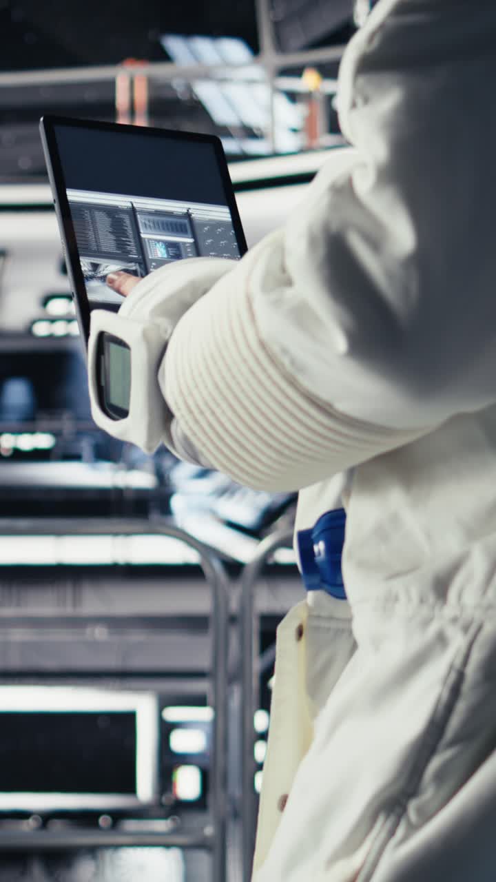 Vertical video Astronaut checking human expansion to Mars mission data on tablet