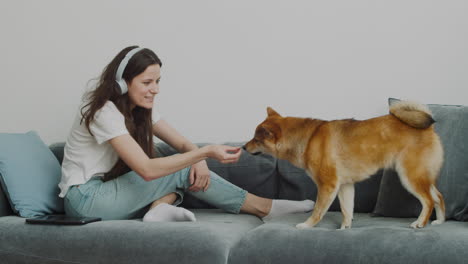 Pretty-Girl-Petting-And-Feeding-Her-Dog-At-Home-1