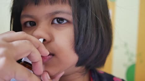 child receiving nasal spray