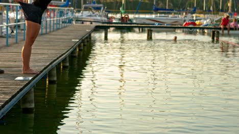 Woman-falling-down-to-the-lake-in-clothes