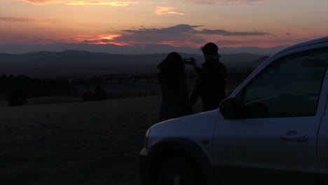 a couple watching a beautiful sunset together