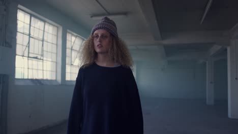 fashionable young woman in an abandoned warehouse