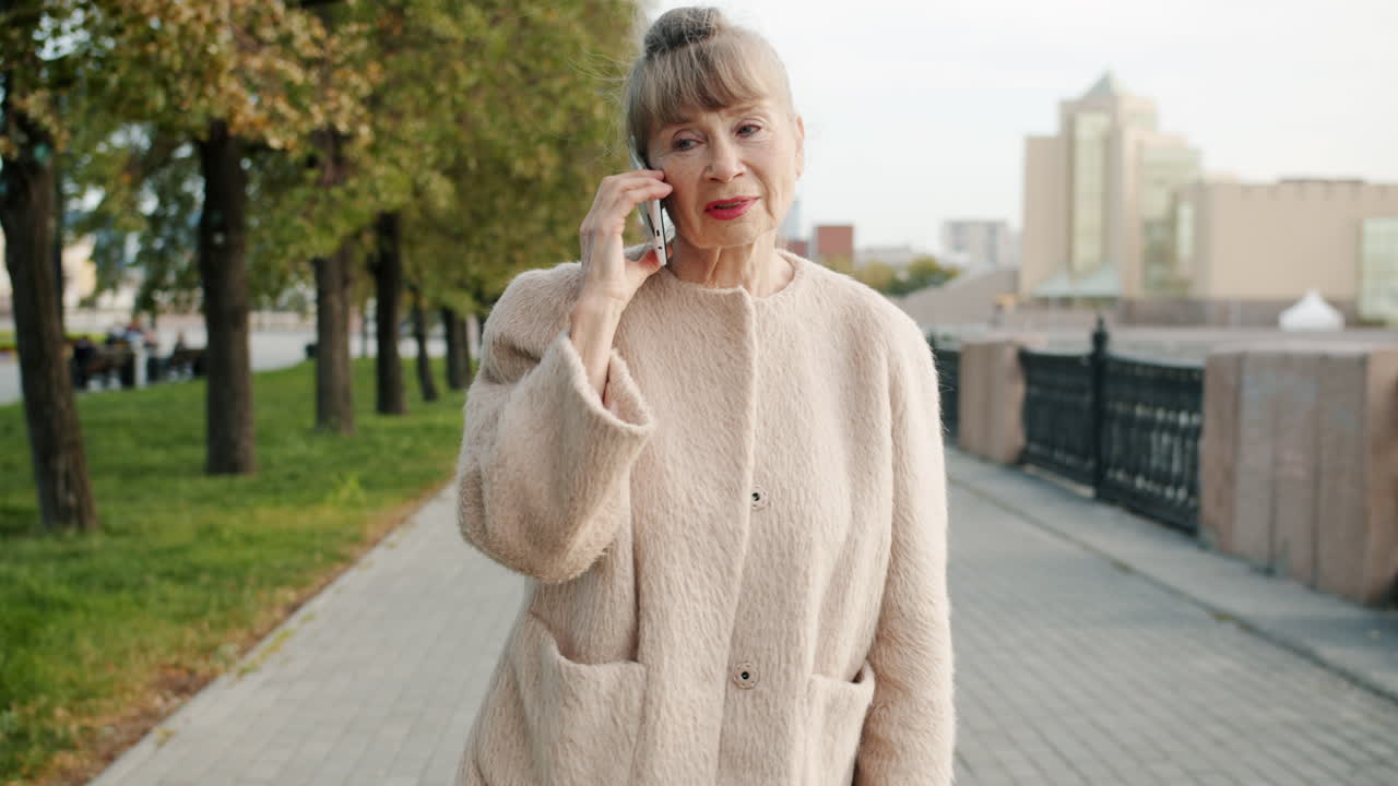 Senior Woman Talking on Phone in a Park