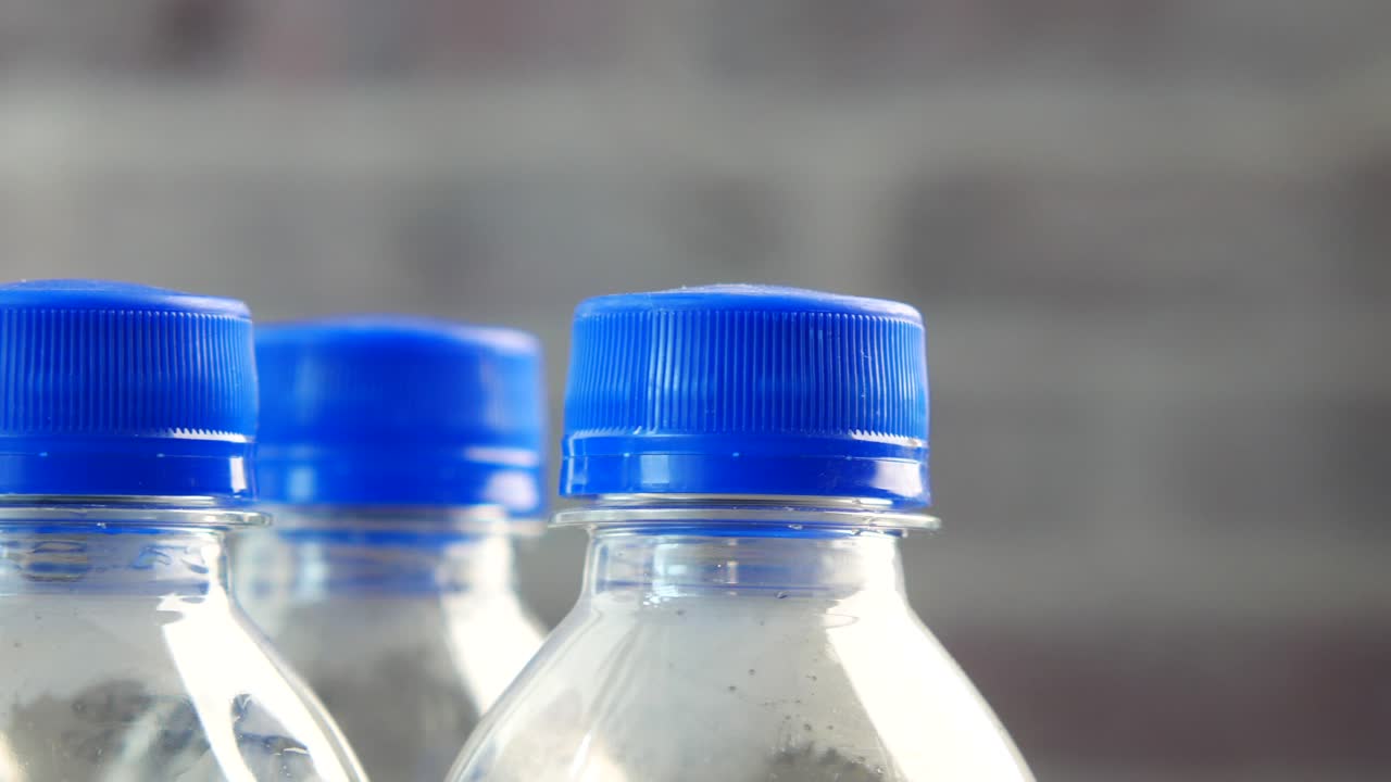 Close up of a Row of Water Bottles with Blue Caps