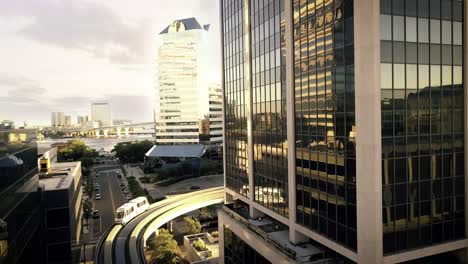 drone shot of downtown jacksonville, florida as the monorail moves along