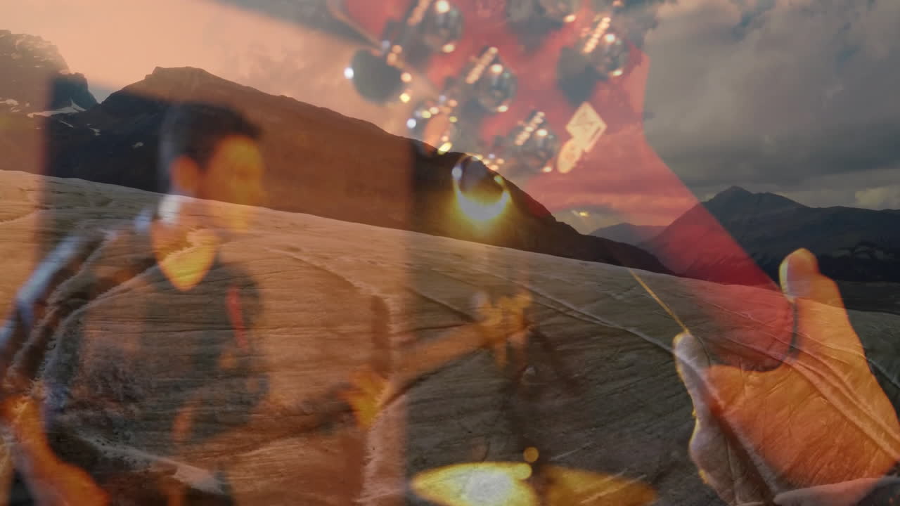 Male athlete running across mountain plain, showing music with red guitar headstock and flares
