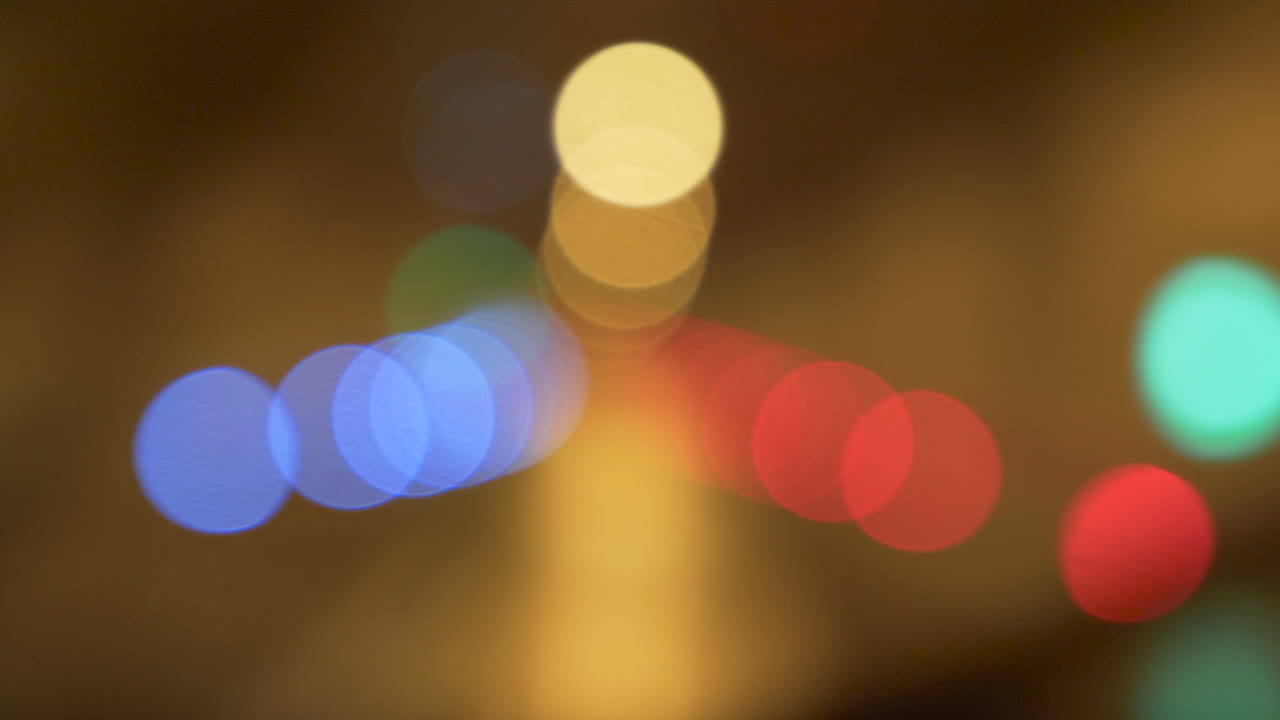 Bokeh artwork, filmed through a window of a car, which drives through a tunnel at night
