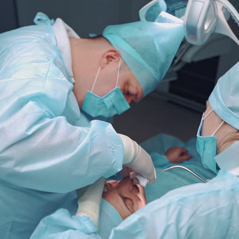 dental specialist and assistant in medical uniform work in stomatology center. doctor and female nurse making medical treatment on teeth for patient. oral surgary.