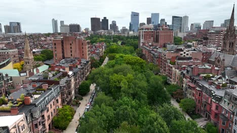 Aerial-dolly-forward-over-green-park-trees-in-suburb-of-Boston,-MA