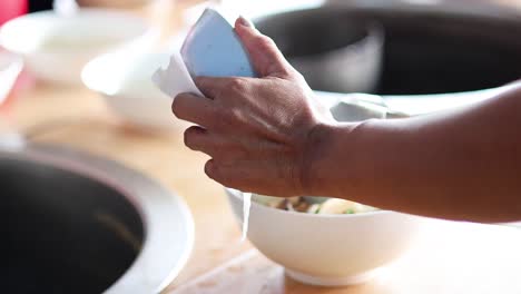 sequential pouring of soup into bowls for serving.